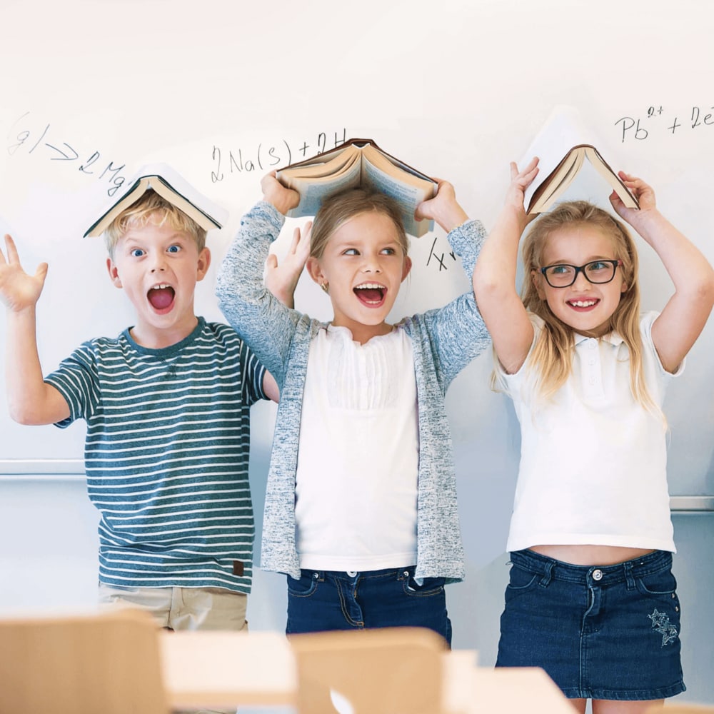 Children with books on their head